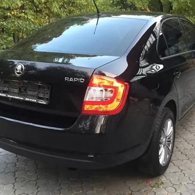 черный седан Шкода сзади